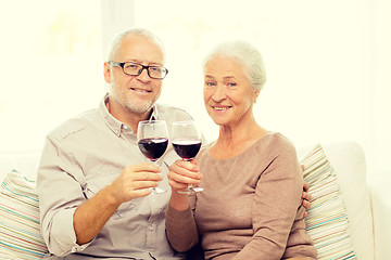Image showing happy senior couple with glasses of red wine