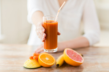 Image showing close up of woman hands with juice and fruits