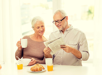 Image showing happy senior couple having breakfast at home