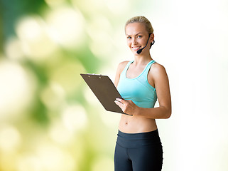 Image showing happy woman trainer with microphone and clipboard