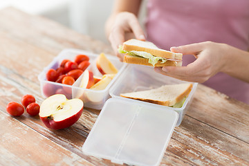 Image showing close up of woman with food in plastic container