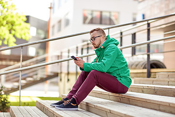 Image showing young hipster man with smartphone in city