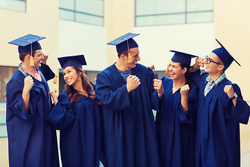 Image showing group of smiling students in mortarboards