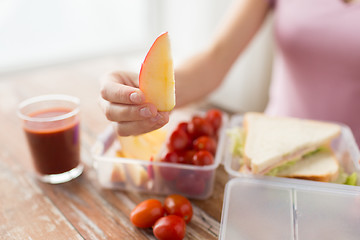 Image showing close up of woman with food in plastic container