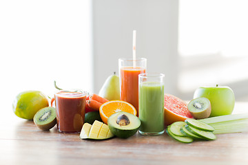 Image showing close up of fresh juice glass and fruits on table