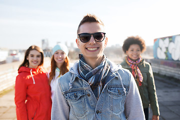 Image showing group of happy teenage friends on city street