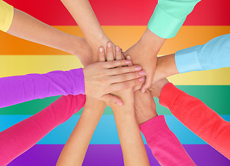 Image showing close up of women with hands on top over rainbow