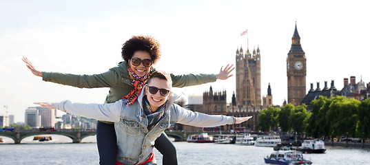 Image showing happy teenage couple having fun over london city