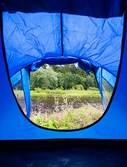 Image showing view from blue tourist tent entrance to nature