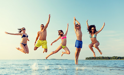 Image showing smiling friends in sunglasses on summer beach