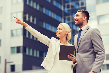 Image showing smiling businessmen with tablet pc outdoors