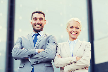 Image showing smiling businessman and businesswoman outdoors