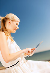 Image showing beautiful woman in a dress with tablet pc