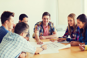 Image showing group of smiling students with blueprint