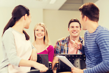 Image showing group of smiling students with notebook