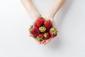 Image showing close up of woman hands holding strawberries