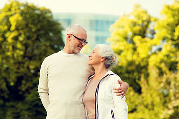 Image showing senior couple hugging in city park