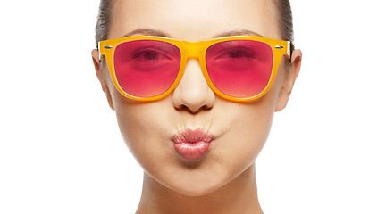 Image showing girl in pink sunglasses blowing kiss