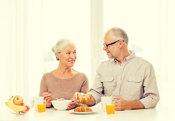 Image showing happy senior couple having breakfast at home