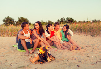 Image showing smiling friends in sunglasses on summer beach