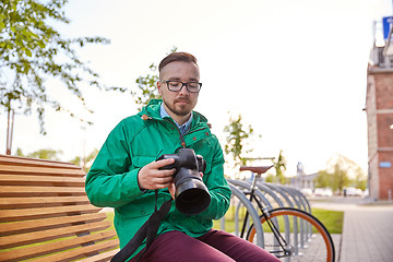 Image showing young hipster man with digital camera in city