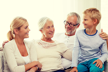 Image showing happy family sitting on couch at home