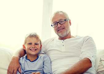 Image showing smiling grandfather and grandson at home