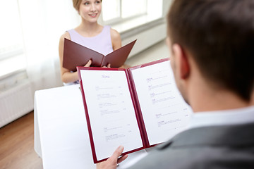 Image showing close up of couple with menu at restaurant