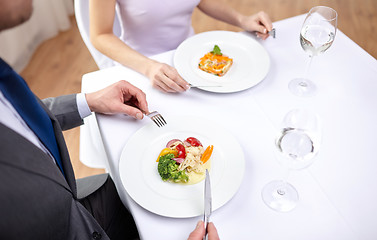 Image showing close up of couple eating appetizers at restaurant