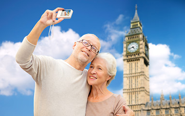 Image showing senior couple taking selfie on camera over big ben