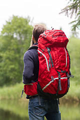 Image showing man with red backpack hiking