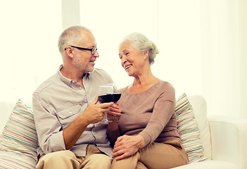 Image showing happy senior couple with glasses of red wine