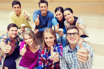 Image showing group of smiling students with paper coffee cups