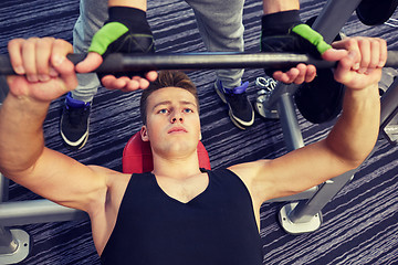Image showing men doing barbell bench press in gym