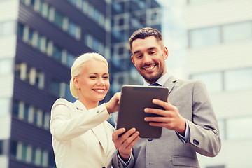 Image showing smiling businessmen with tablet pc outdoors