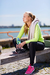 Image showing woman resting after doing sports outdoors