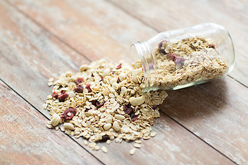 Image showing close up of jar with granola or muesli on table