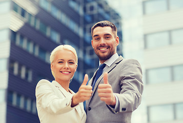 Image showing smiling businessmen showing thumbs up