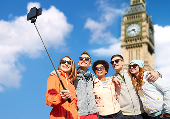 Image showing smiling friends taking selfie with smartphone