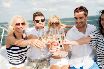 Image showing happy friends with glasses of champagne on yacht