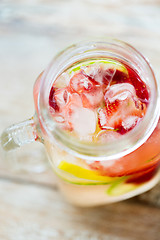 Image showing close up of fruit water in glass bottle