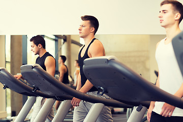 Image showing group of men exercising on treadmill in gym