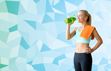 Image showing woman with bottle of water and towel