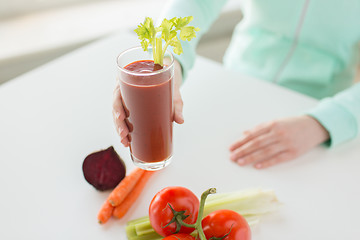 Image showing close up of woman hands with juice and vegetables