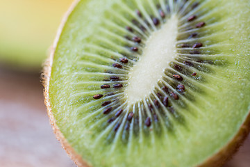 Image showing close up of ripe kiwi slice on table