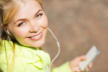 Image showing woman listening to music outdoors