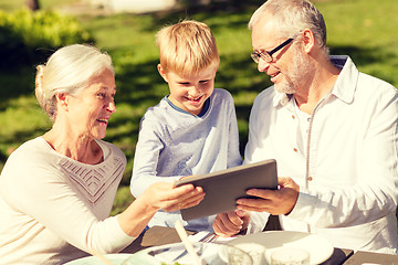 Image showing happy family with tablet pc outdoors