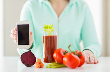 Image showing close up of woman with smartphone and vegetables