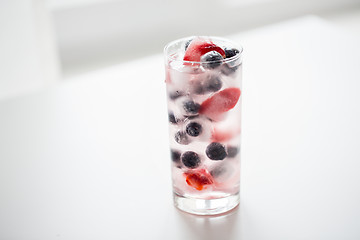 Image showing close up of fruit water with ice cubes in glass