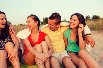 Image showing smiling friends in sunglasses on summer beach